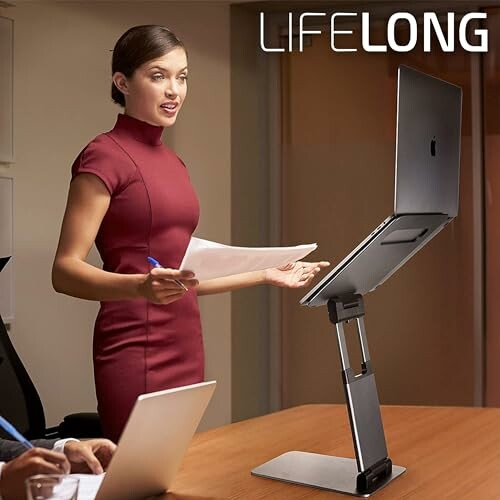 Woman presenting with adjustable laptop stand in a meeting