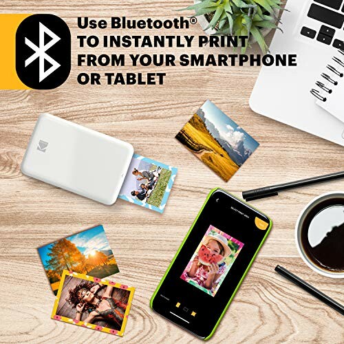 Bluetooth photo printer with smartphone and printed photos.