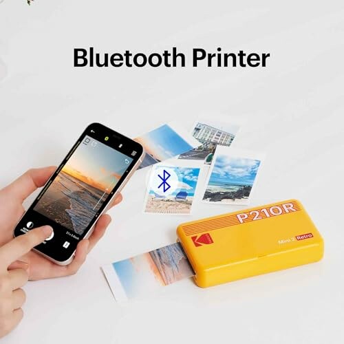 Portable Bluetooth printer printing photos from a smartphone.