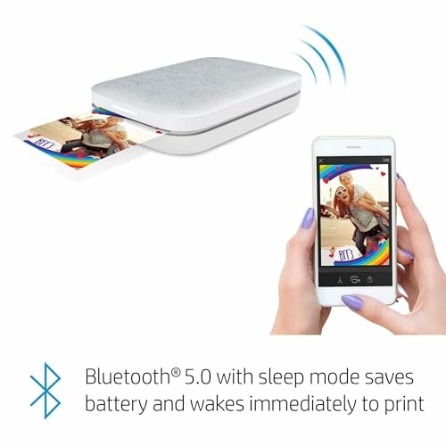 Portable photo printer printing a photo from a smartphone via Bluetooth.