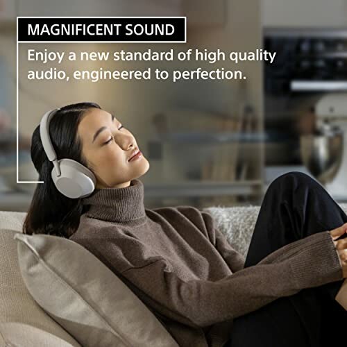 Woman relaxing on a couch wearing headphones, experiencing high-quality sound.